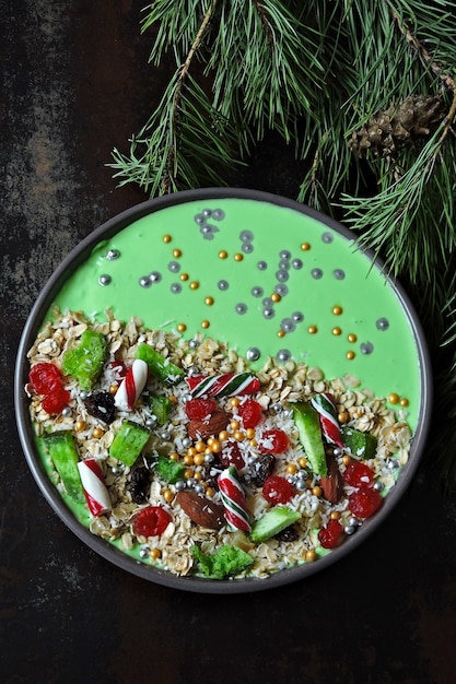 Christmas breakfast bowl. Christmas tree branches and Christmas decorations.