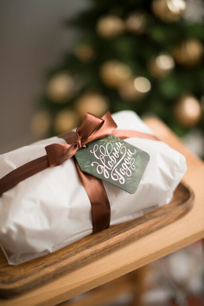 A Christmas bundle decorated with a ribbon lies with the tag Happy New Year