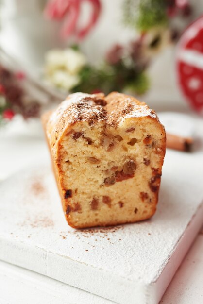 Christmas cake, milk, cinnamon on a white by the window