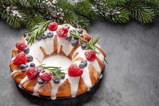 Christmas cake with berries and fir tree