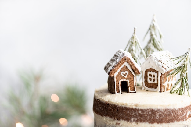 Christmas cake with gingerbread houses new year card place for text selective focus