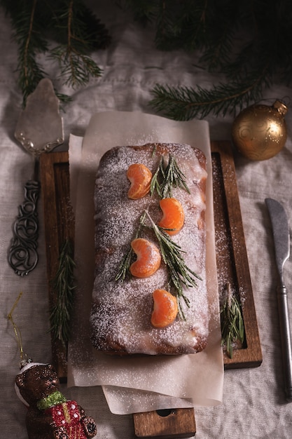 Christmas cake with tangerine on the table