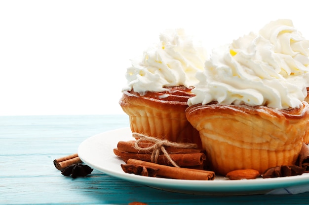 Christmas cakes with whipped cream on a wooden background. Place for text. Top view.