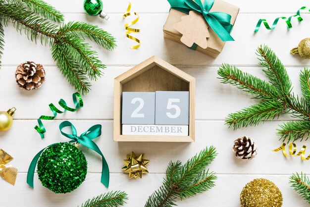 Christmas calendar 25 december christmas gift fir branches pine cones flat lay top view new year decorations on a colored background