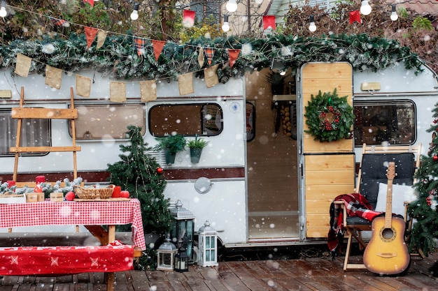 Christmas camping. The trailer is decorated with Christmas decor.