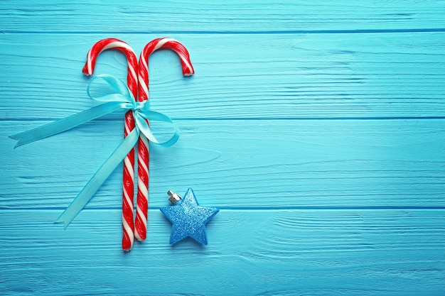 Christmas candies with ribbon on table