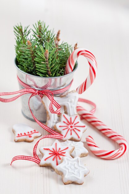 Christmas candy canes, cookies and pot with ribbon