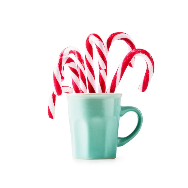 Christmas candy canes in cup isolated on white background clipping path included. Design element