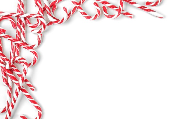 Christmas candy canes on white surface surface