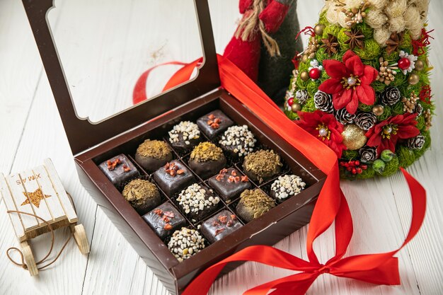 Photo christmas candy on a white wooden table.