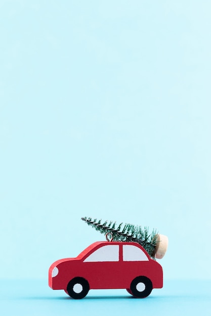 Christmas car on pastel color background. Christmas or New Year minimal concept.