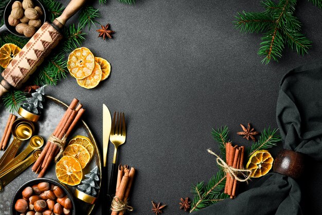 Photo christmas card background with christmas winter spices and ingredients for baking on a dark slate