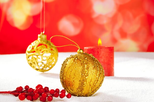 Christmas card of golden baubleand candle