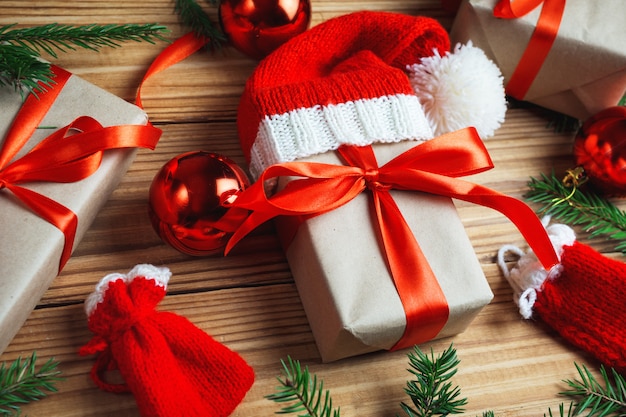 Christmas card. Holiday gifts with fir branches on wooden table