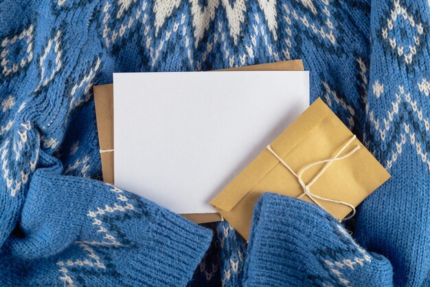 Christmas card mock up on blue sweater. Nobody flat lay.