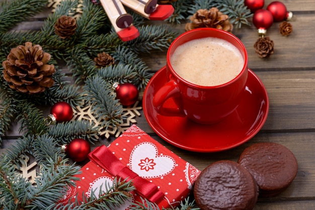 Christmas card with coffee and cookie on wooden background