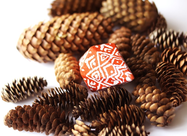 Christmas card with fir-tree cones and decor.