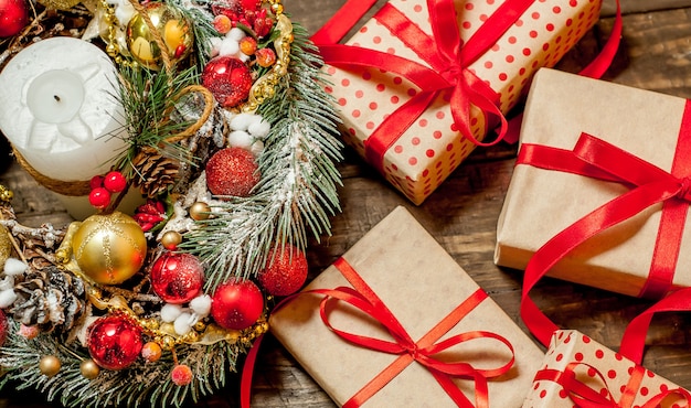 Christmas card with gift box and toys on a wood background.