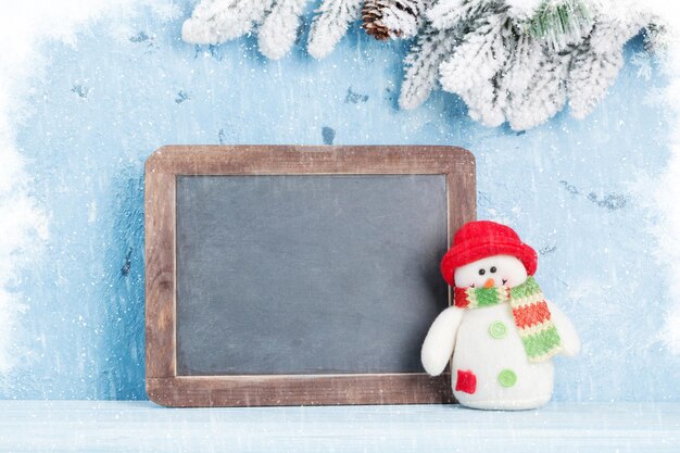 Christmas chalkboard snowman and fir tree view with copy space for your text