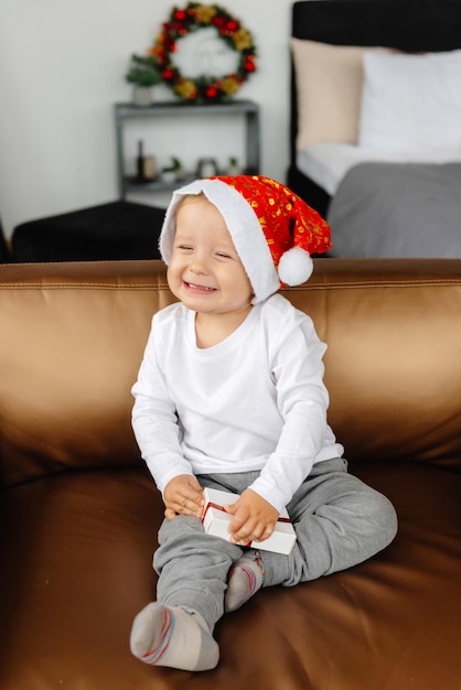 Christmas child opens a gift happy boy tries to open a box of gifts