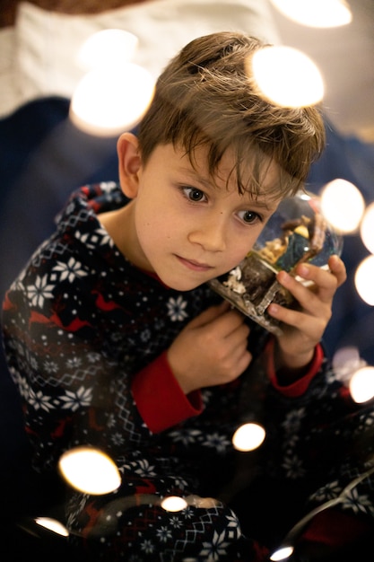 Christmas childhood boy dreams of evening Christmas tree holiday flashlights