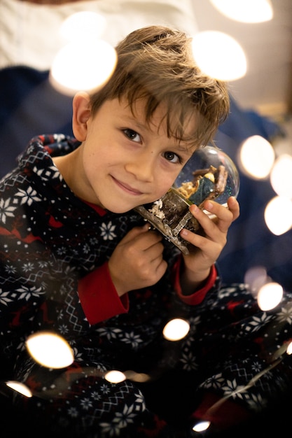 Christmas childhood boy dreams of evening Christmas tree holiday flashlights