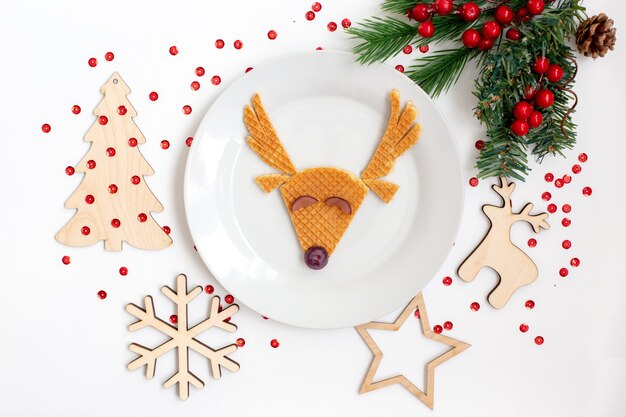 Christmas children's dish featuring a deer. Flat lay