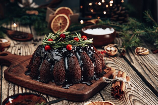 Christmas chocolate cake decorated with berries and rosemary