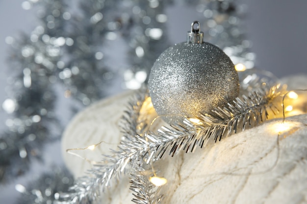 Christmas Christmas toy ball and garland on a knitted sweater