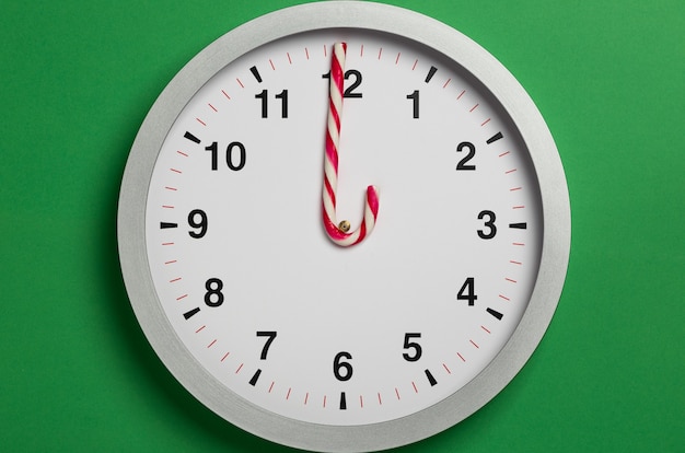 Christmas clock with candy cane hands shows twelve oclock