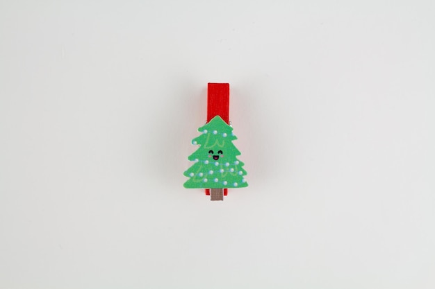 Christmas clothespin on white with christmas tree