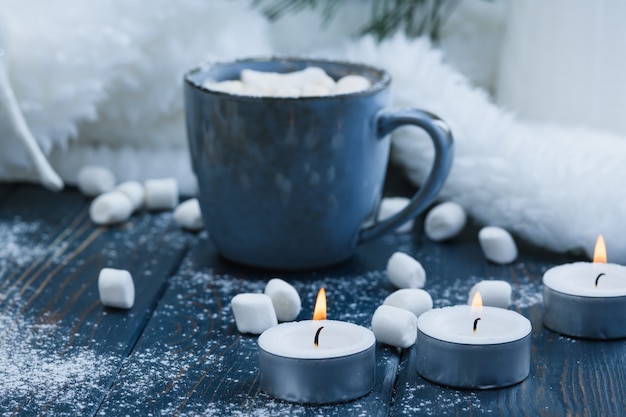 Christmas cocoa with marshmallows on blue table