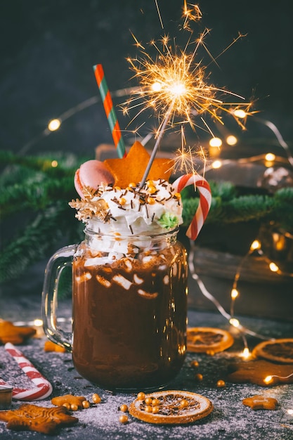 Christmas cocoa with sparklers lights, New Year card, Atmospheric photo, Hot chocolate drink on dark