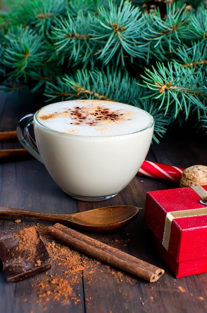 Christmas coffee with milk cocoa branches spruce cones 