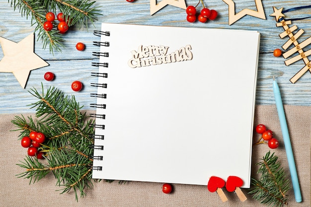 Christmas composition of Blank notepad with the inscription merry Christmas on wooden background