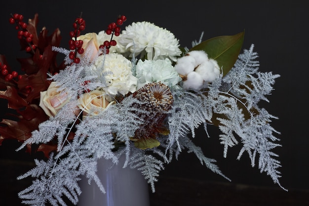 Christmas and  composition bouquet in a ceramic vase on a dark , selective focus