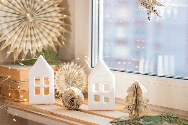 christmas composition by the window houses snowflakes fir