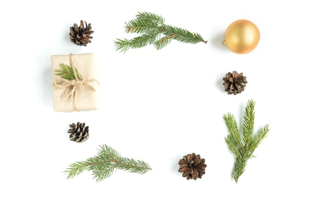 Christmas composition of Christmas balls, gift box, cones and fir branches isolated on white surface. Flat lay, top view, copy space