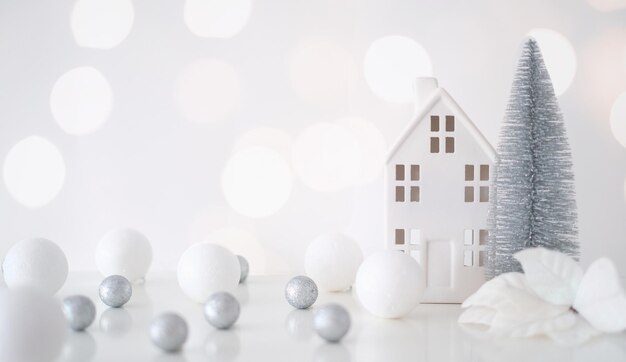 Christmas composition Christmas balls white and silver decorative house christmas tree on a white background