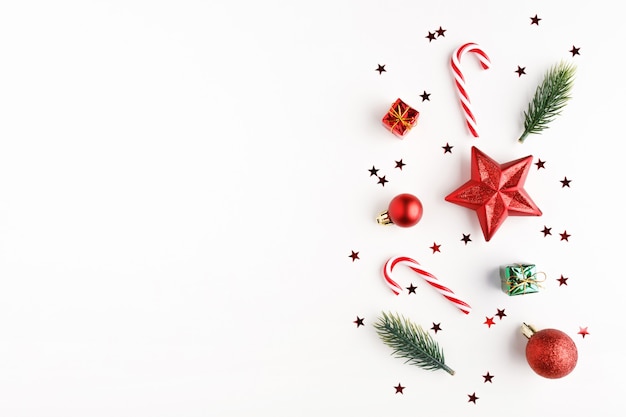 Christmas composition. Christmas candy canes, gifts, balls and fir branches. Flat lay, top view