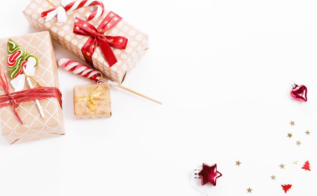 Christmas composition. Christmas red decorations, gifts, pine cones red background. Flat lay, top view, copy space