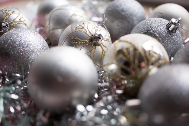 Christmas composition. Christmas silver balls decorations on white tinsel background. Close up