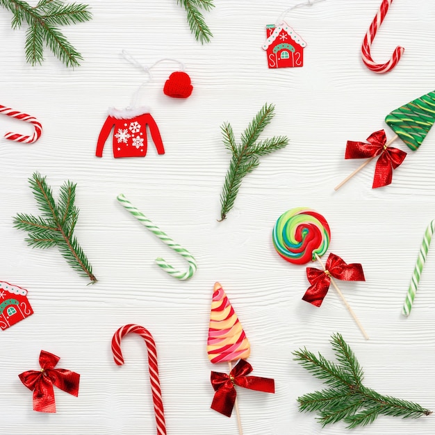 Christmas composition Christmas sweets and candy canes pine branches and  New Year wooden toys