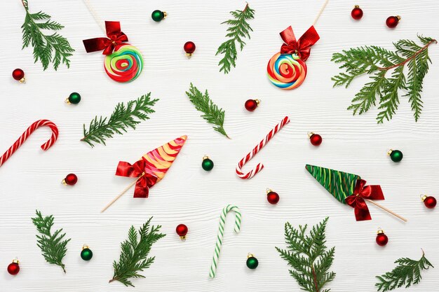 christmas composition christmas sweets and candy canes thuja branches and new year small balls