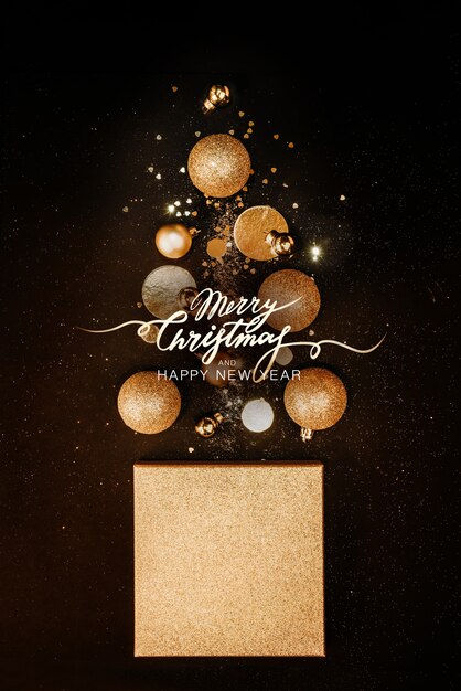 Christmas composition. Christmas tree concept with golden decorations, balls, glitters on a black background. background. Christmas, new year concept. Minimalism flat lay