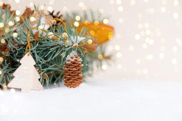 Фото Новогодняя композиция шишки в снегу боке гирлянды снежные еловые ветки