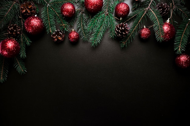 Christmas composition of fir tree branches with baubles and cones 