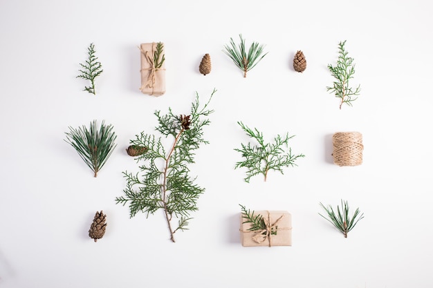 Christmas composition. Gift, christmas decoration, cypress branches, pine cones on white background