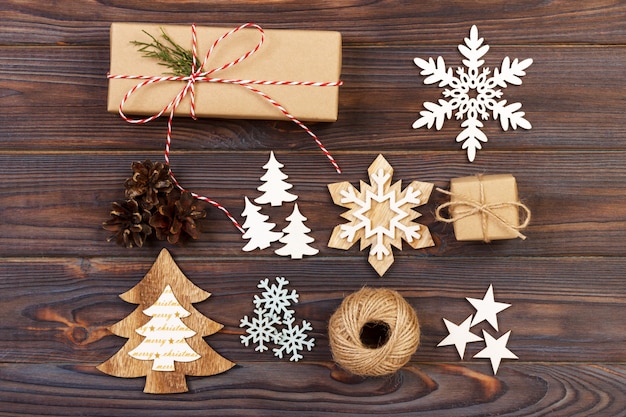 Christmas composition. Gift, christmas decoration, snowflake, pine cones. Flat lay top view