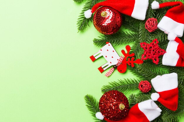 Photo christmas composition made of fir tree balls and different decorations on colorful background top view of new year advent concept with empty space for your design